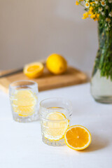 Glass with lemonade or mojito cocktail on white background for summer party. Summer drinks with ice