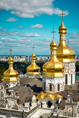 Fototapeta na wymiar Stunning view of the city of Kyiv, Ukraine through the golden church rooftops. Beautiful colours run through this image. Great sky