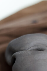 ceramics designer glass made of black gray clay. Ceramist concept. gray clay closeup with blurry background.