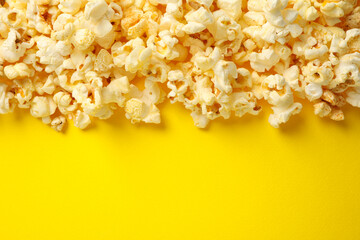 Tasty popcorn on yellow background. Food for watching cinema