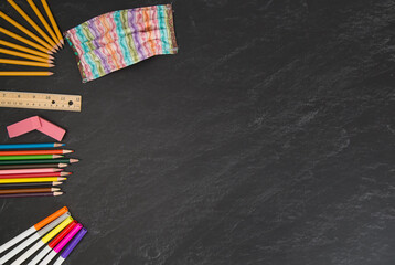 Pink pastel striped face mask with back to school supplies on chalkboard