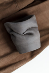 ceramics designer glass made of black gray clay. Ceramist concept. gray clay closeup with blurry background.