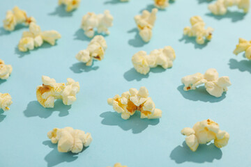 Flat lay with popcorn on blue background. Food for cinema