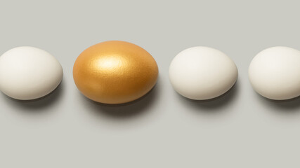 Concept of individuality, exclusivity, better choice. One golden egg among white eggs. Top view.
