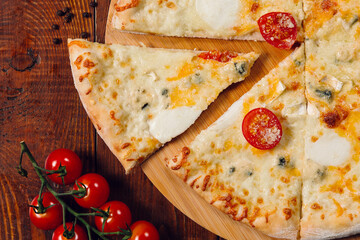 four cheese pizza on wooden table in a restaurant