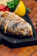 fried fish on the table in a restaurant, breaded dorado