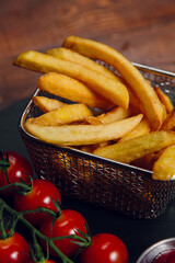 French fries and tomatoes on a table in a restaurant. Fast food, junk food