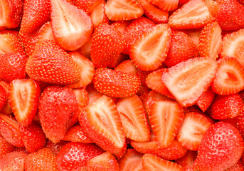 Sliced strawberries as texture and background. Colorful background. Selective focus.