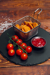 French fries and tomatoes on a table in a restaurant. Fast food, junk food