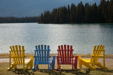 Multi-colored Adirondack lawn chairs on the lawn in front of Jasper Lake Lodge, Jasper, Alberta, Canada.