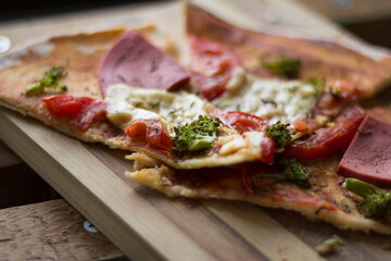 pizza with ham tomato cheese and broccoli