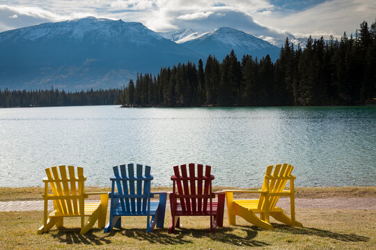 Multi-colored adirondack lawn chairs on the lawn in front of Jasper Lake Lodge, Jasper, Alberta, Canada.