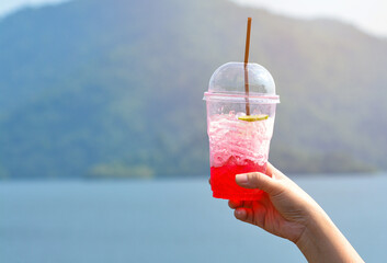 A cup of iced red soda.