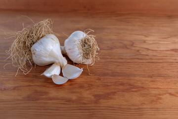 Untrimmed garlic bulbs on cutting board - 362971185