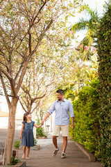 .Father and daughter walking outdoors. Showing affection and love. Father's Day.