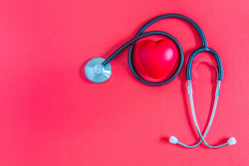 Red heart and stethoscope on red background