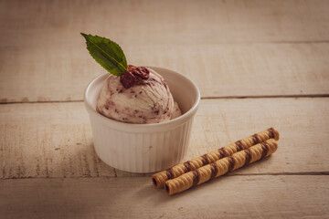 Scoops of ice cream on wooden background