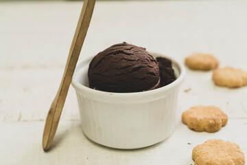 Scoops of ice cream on wooden background