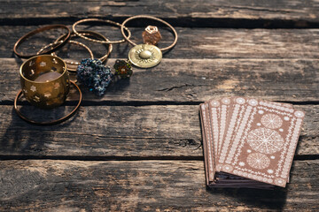 Tarot cards deck on the old wooden table background.