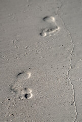 Fototapeta na wymiar footprints on beach sand peaceful journey in solitude barefoot track to freedom and exploration