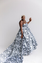 Fototapeta na wymiar Afro-American plus size gorgeous woman modeling ethnic romantic gowns