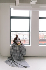 Afro-American plus size gorgeous woman modeling ethnic romantic gowns