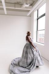 Afro-American plus size gorgeous woman modeling ethnic romantic gowns