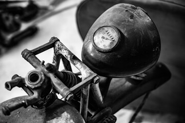 Grayscale closeup of a vintage motorcycle speedometer