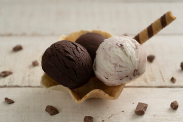 Scoops of ice cream on wooden background