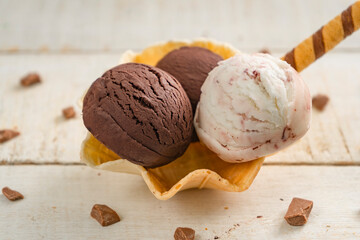 Scoops of ice cream on wooden background