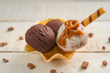 Scoops of ice cream on wooden background