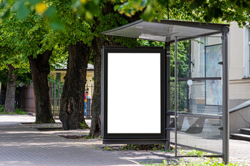 white blank advertising banner at a public transport stop of a trolley bus in the city near the park