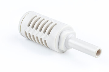 Macro shoot of a white pneumatic air silencer mounted on a quick coupling for pneumatic installations, isolated on a white background with a clipping path.