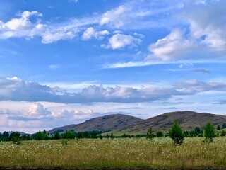 Fototapeta premium Magnificent mountains. Field in mountainous rural area. beautiful countryside scenery with lovely sky on a summer day