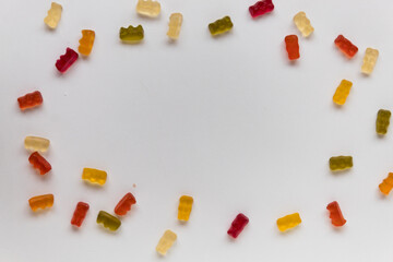 jelly bears on a white table scattered in a circle