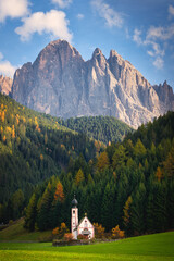 Church with Dolomites mountains in autumn