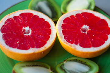 Minimal fruit background. Top view of sliced citrus fruits grape