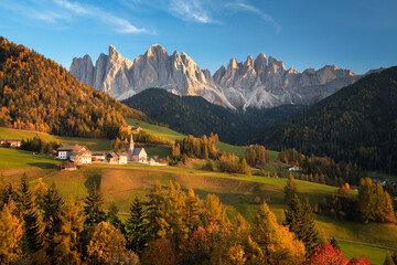 Autumn landscape with church and Dolomites mountains