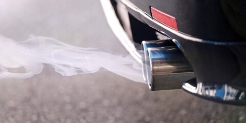 Fototapeta premium Smoky dual exhaust pipes from a starting diesel car.