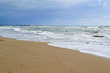 Tropical beach with colorful sunset, cloudy sky. A copy of the space