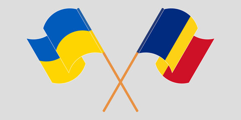 Crossed and waving flags of the Ukraine and Romania. Vector illustration