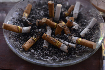 used cigarettes in ashtrays with selective focus