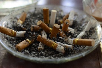 used cigarettes in ashtrays with selective focus