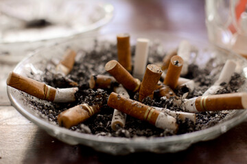 used cigarettes in ashtrays with selective focus