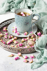 Rose buds tea, tea cup, strainer  with rosebuds on  vintage tray