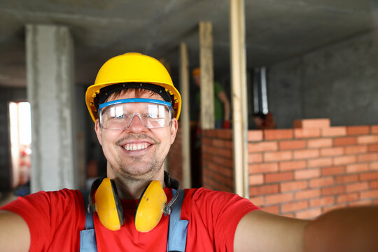 Brick wall behind male