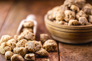 Granulated PINK SOY PROTEIN. used in vegan foods as a meat substitute. Food supplement.
