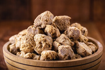 vegan food, coarse soy protein, also called soy meat, the protein textured in pieces inside a wooden bowl