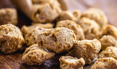 vegan food, coarse soy protein, also called soy meat, the protein textured in pieces inside a wooden bowl