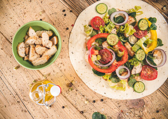 Delicious tortilla wraps on wooden table with vegetable